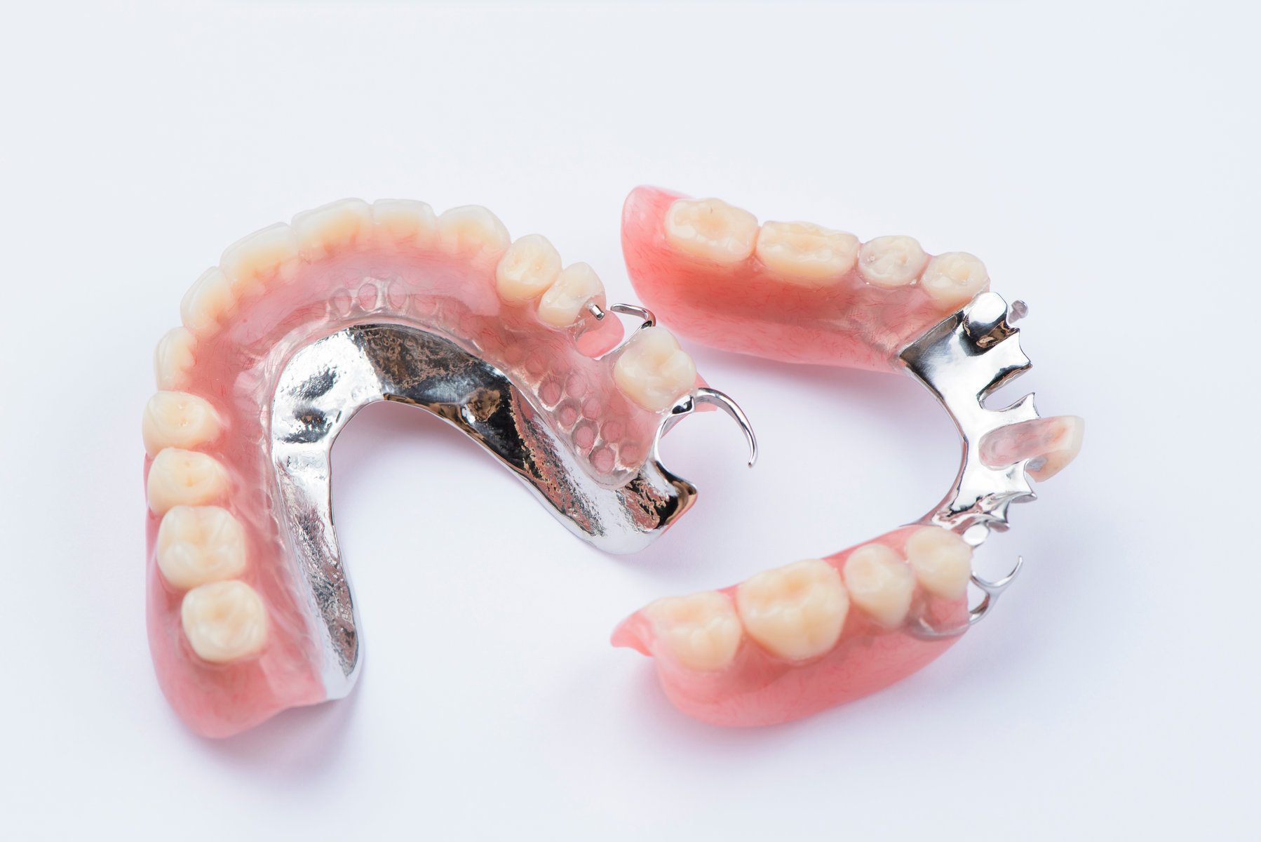 Removable metal partial denture on white background