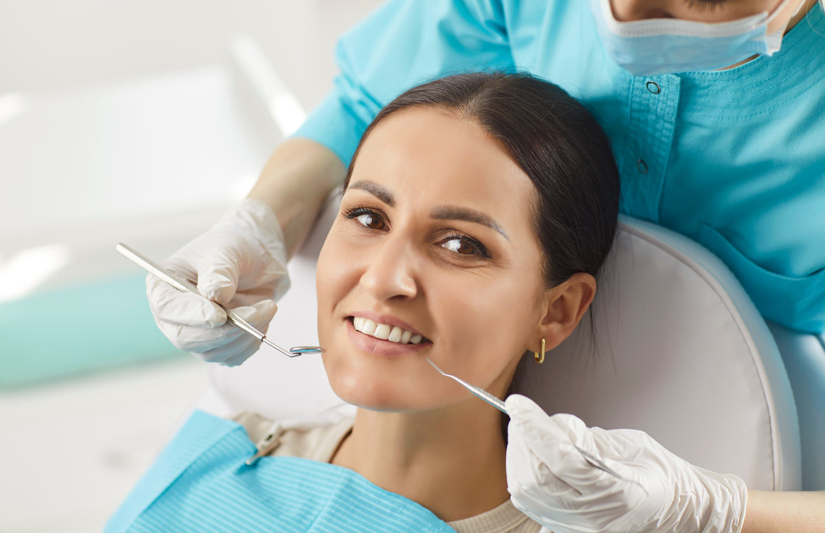 Happy smiling woman in dental clinic for oral health treatment, dentist exam, teeth, gums care, healthy doctor visit, whitening teeth procedure result, satisfied with stomatology modern clinic service