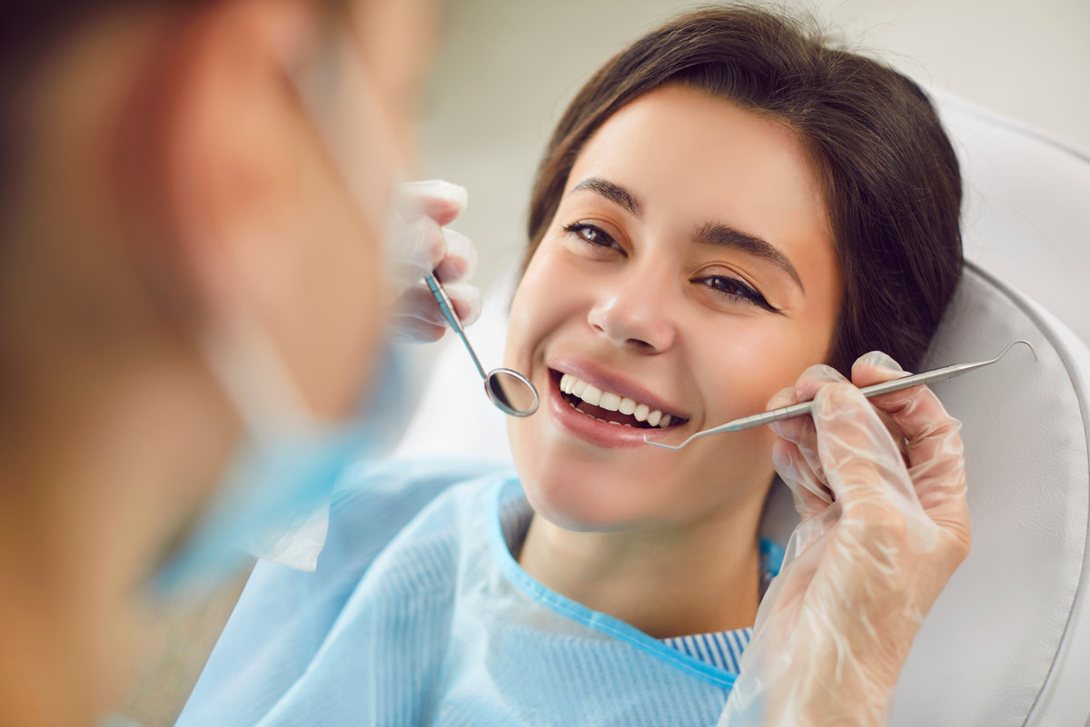 Dentist doctor performing a medical check up on a patient teeth during a visit to hospital. Oral care session emphasizes the importance of regular dental examinations in maintaining good oral health.