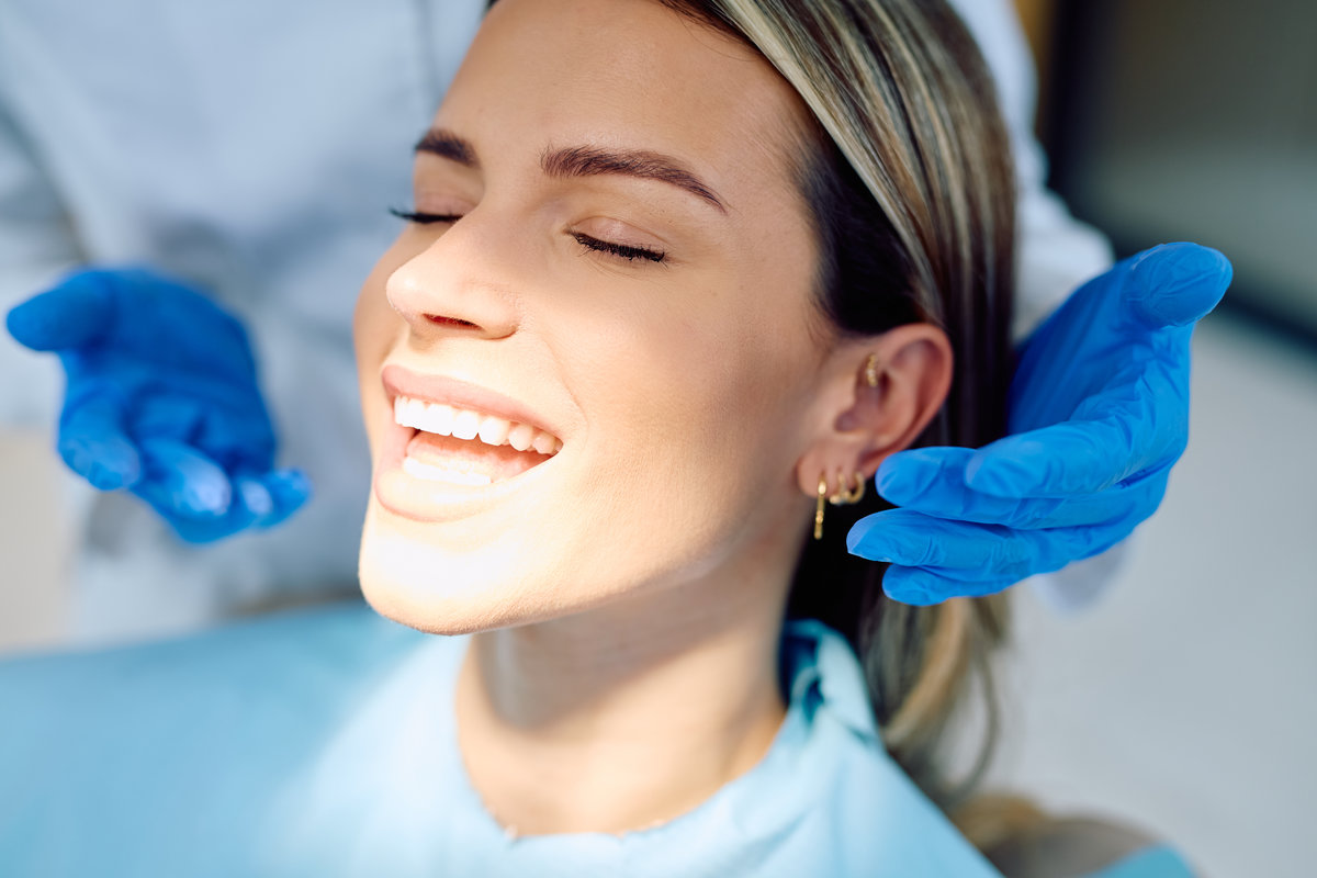Woman smiling showing white teeth at dentist