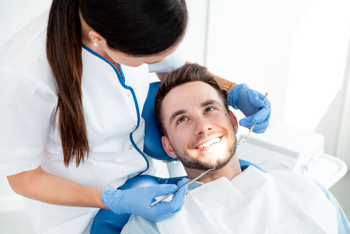 Man having teeth examined at dentists. Overview of dental caries prevention