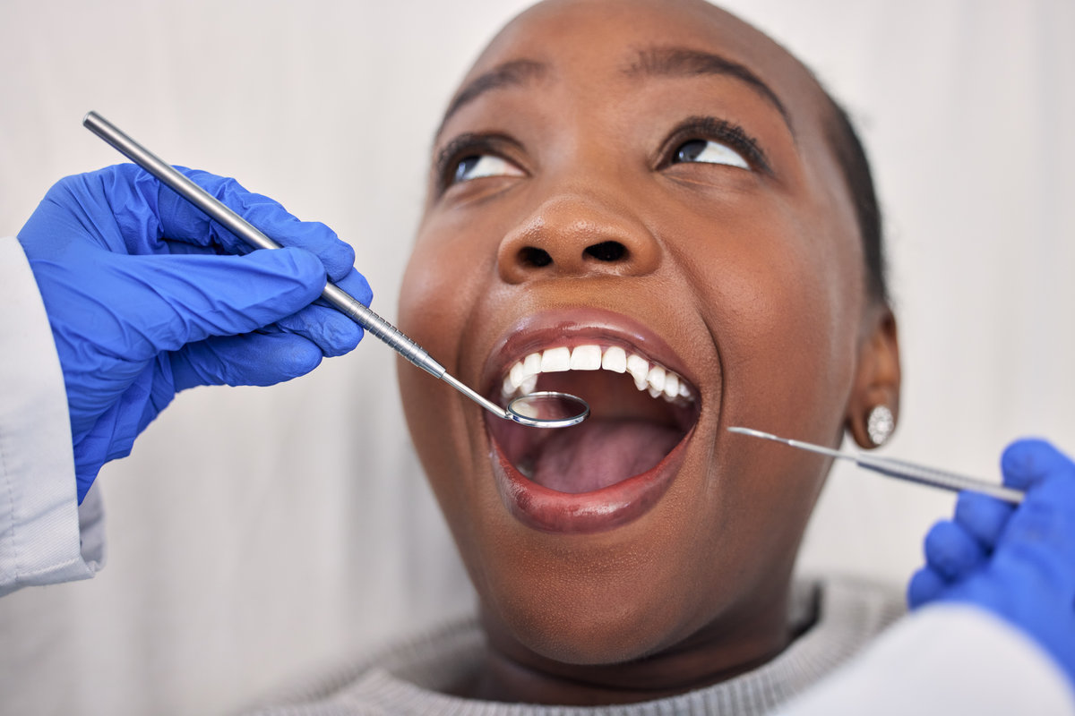 Dentist hands, patient mouth and tools, check teeth for dental health and medical treatment. Oral hygiene, healthcare and orthodontics, black woman with tooth decay and clean for cavity and excavator.